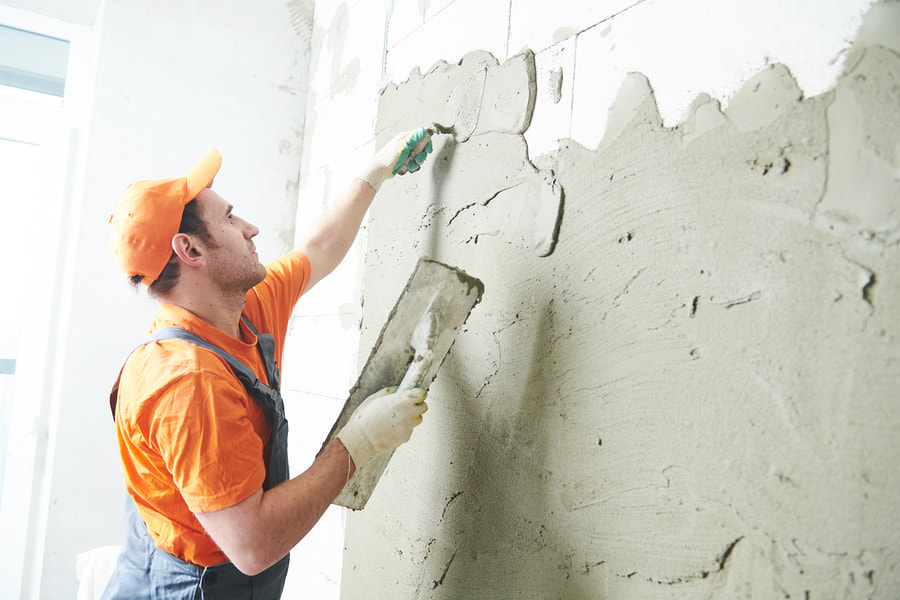 man doing stucco repair